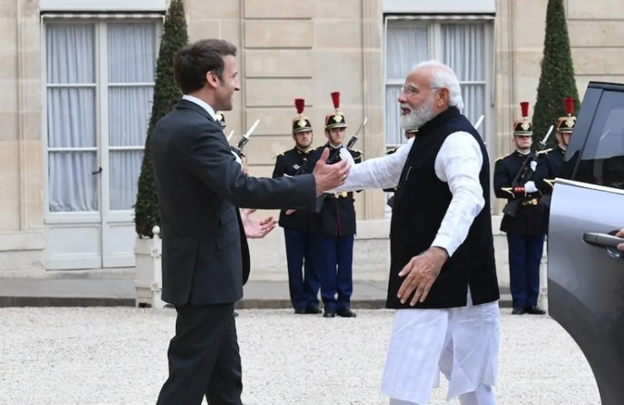 French President Emmanuel Macron welcoming PM Modi