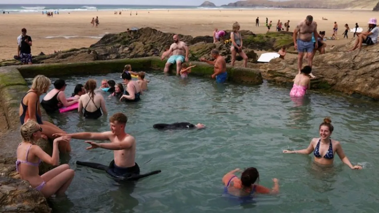 Large crowds gathering at pools and beaches to beat the heat in UK