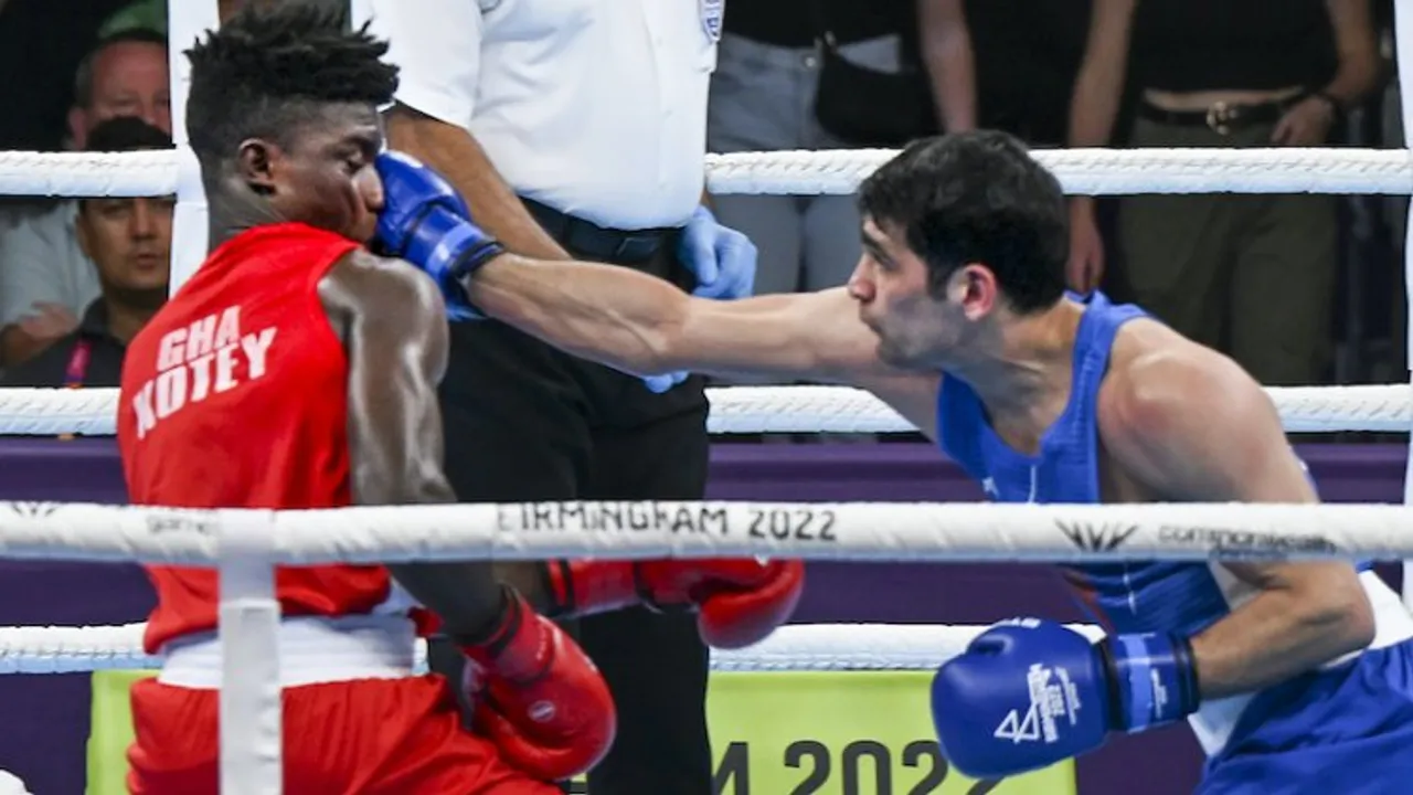 India's Rohit Tokas (blue) lands a punch on Ghana's Alfred Kotey during the mens over 63.5kg-67kg (Welterweight) Round of 16 boxing match, at the Commonwealth Games 2022 (CWG), in Birmingham, UK, on Tuesday