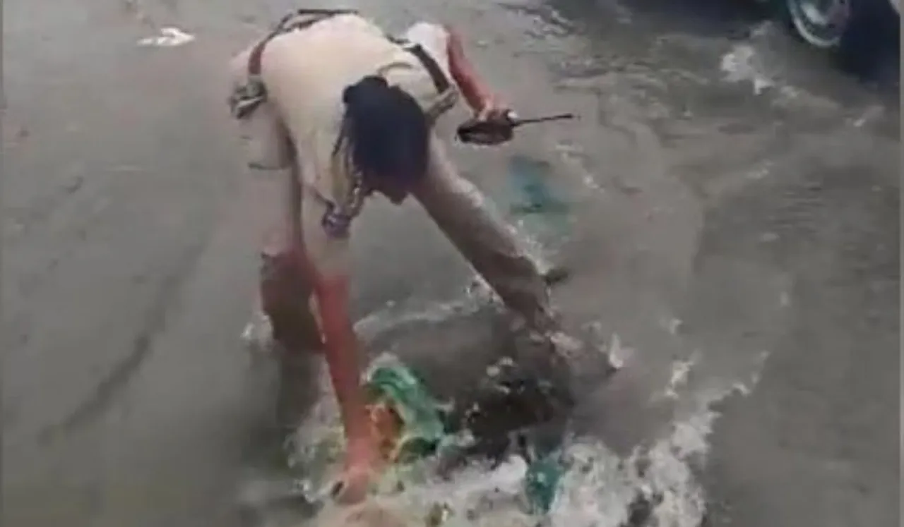 Woman Cop Cleans Drainage With Hands