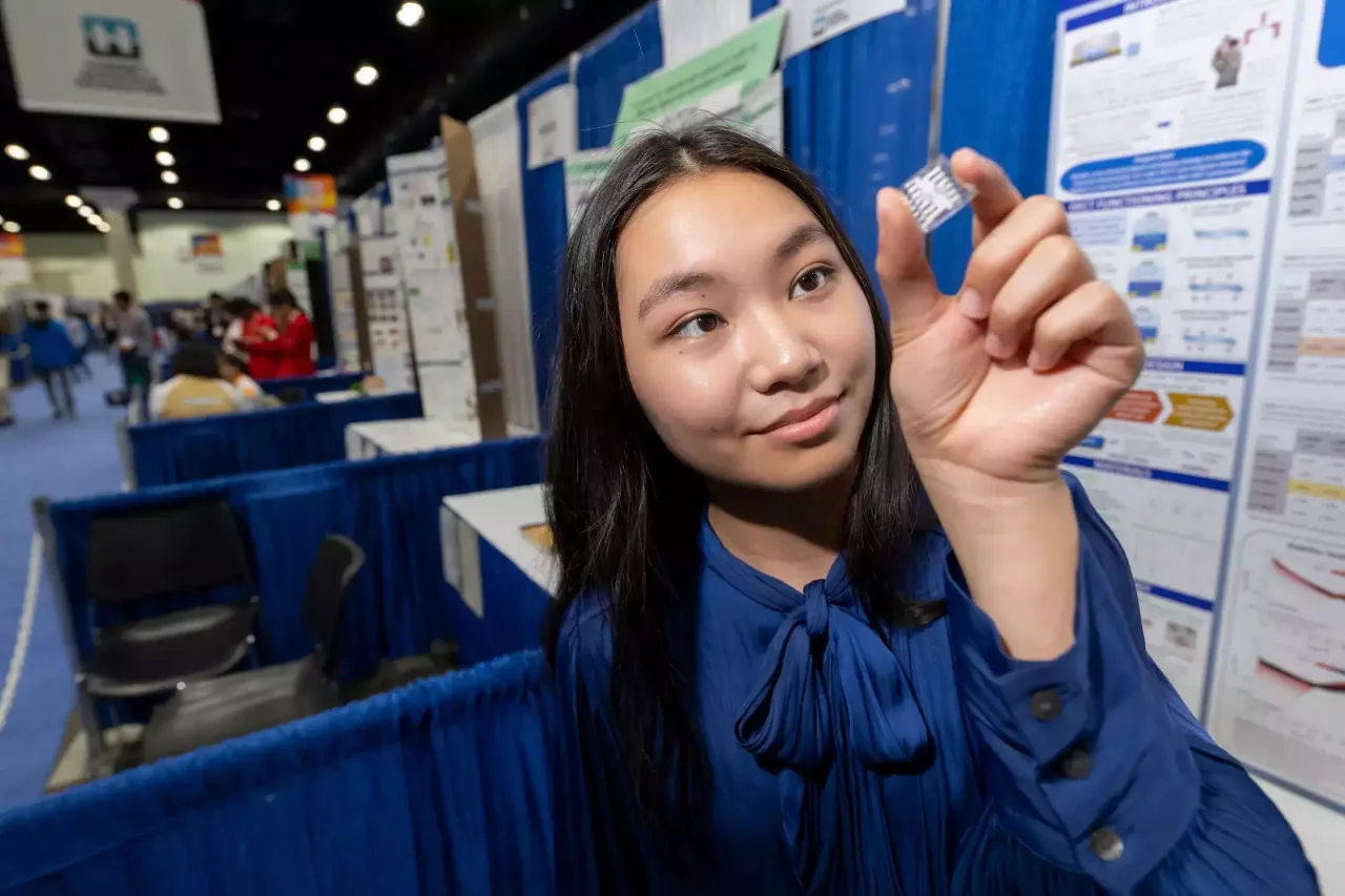 Chris Ayers/Society for Science,Grace Sun holds an OECT device that helped her win the ISEF science fair.   