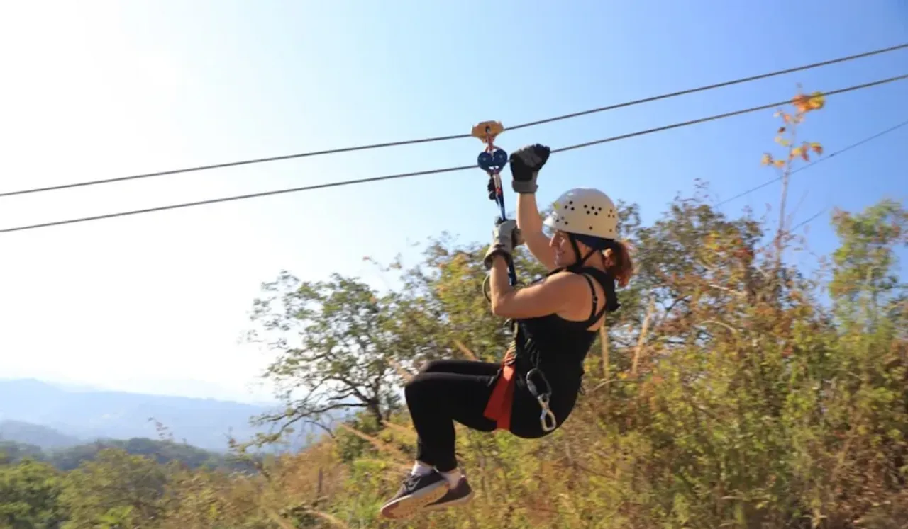 credit, Image credit: Ty Downs, Unsplasha woman is zipping through the air on a zip line