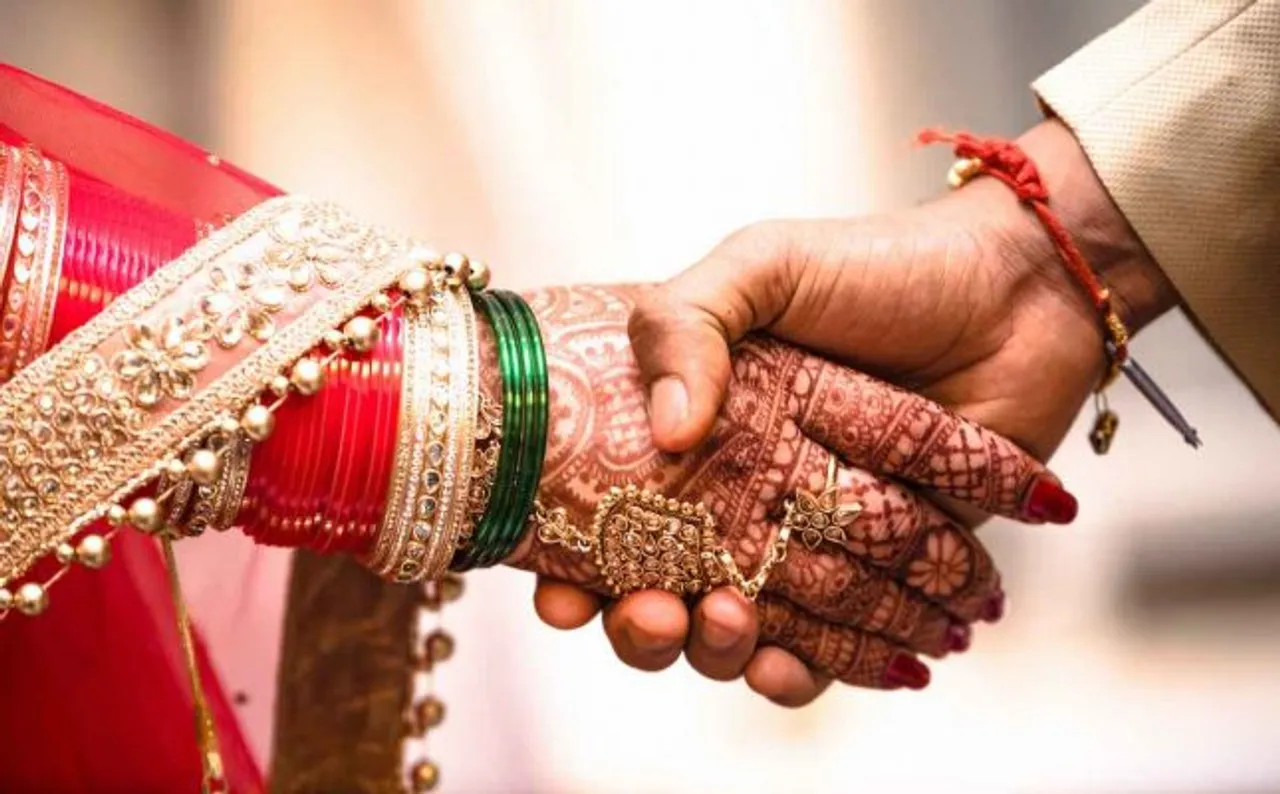 punjabi wedding couples holding hands