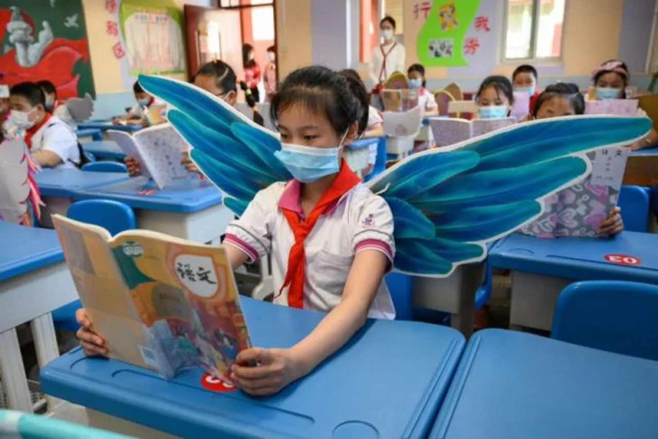 In China, Students Wear DIY Wings & Hats To Maintain Social-distancing
