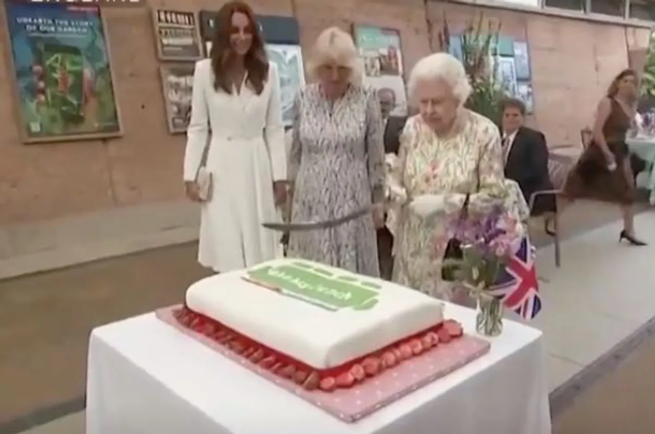 Something That Is More Unusual: Queen Elizabeth II Cuts Cake With Ceremonial Sword At G7 Summit
