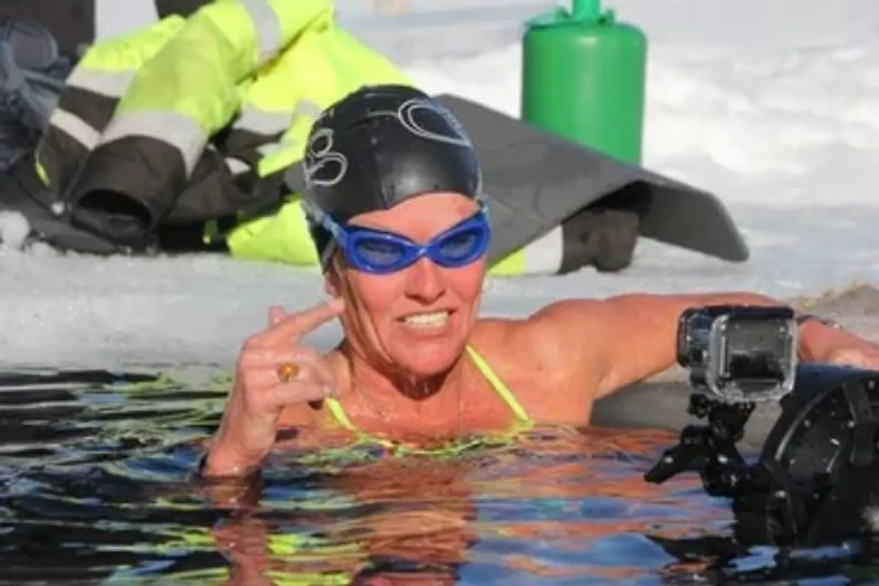 woman swims under ice