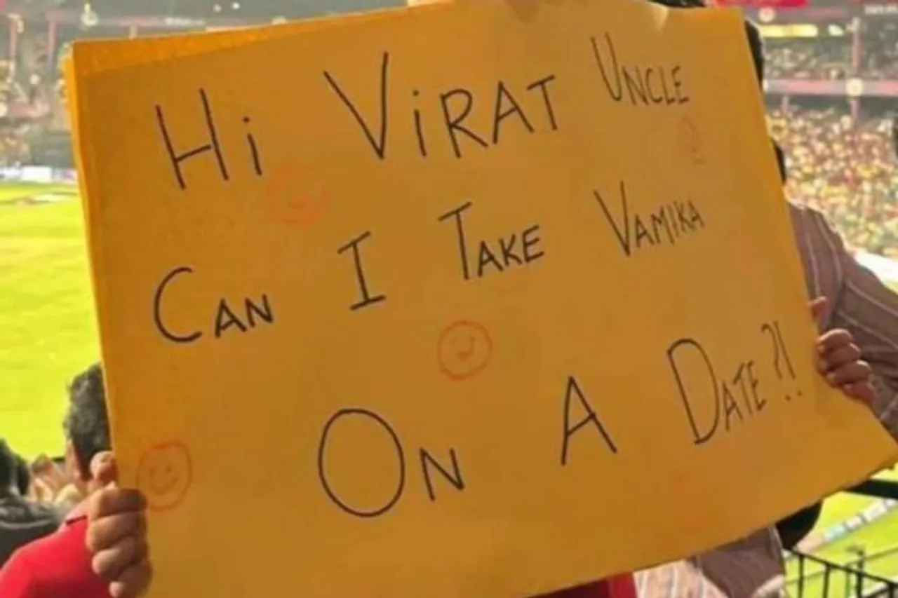 kid holds banner for vamika kohli