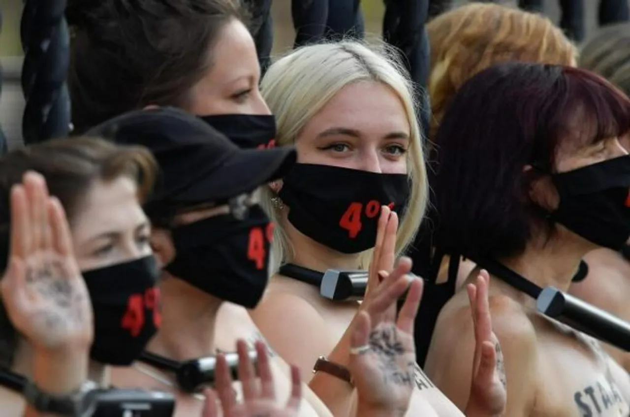 Bare-Chested Women Lock Themselves To UK Parliament In Climate Protest