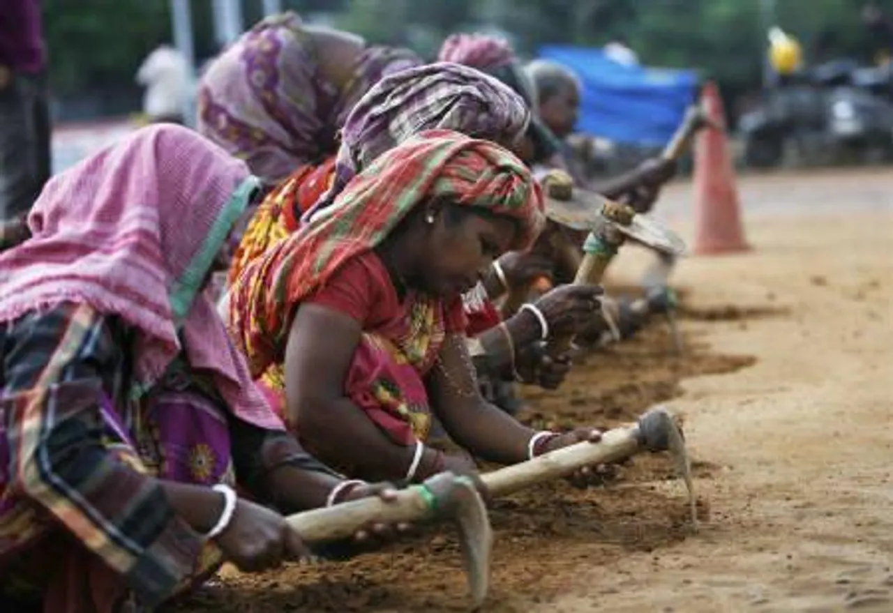telangana woman sarpanch becomes labourer, Women in India: Woman labourers work at a road construction site