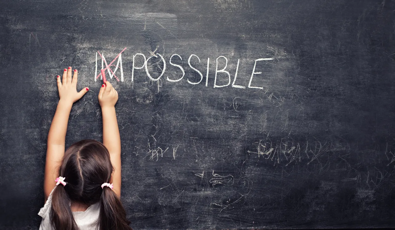 Girl writing on black board by NCGBlog