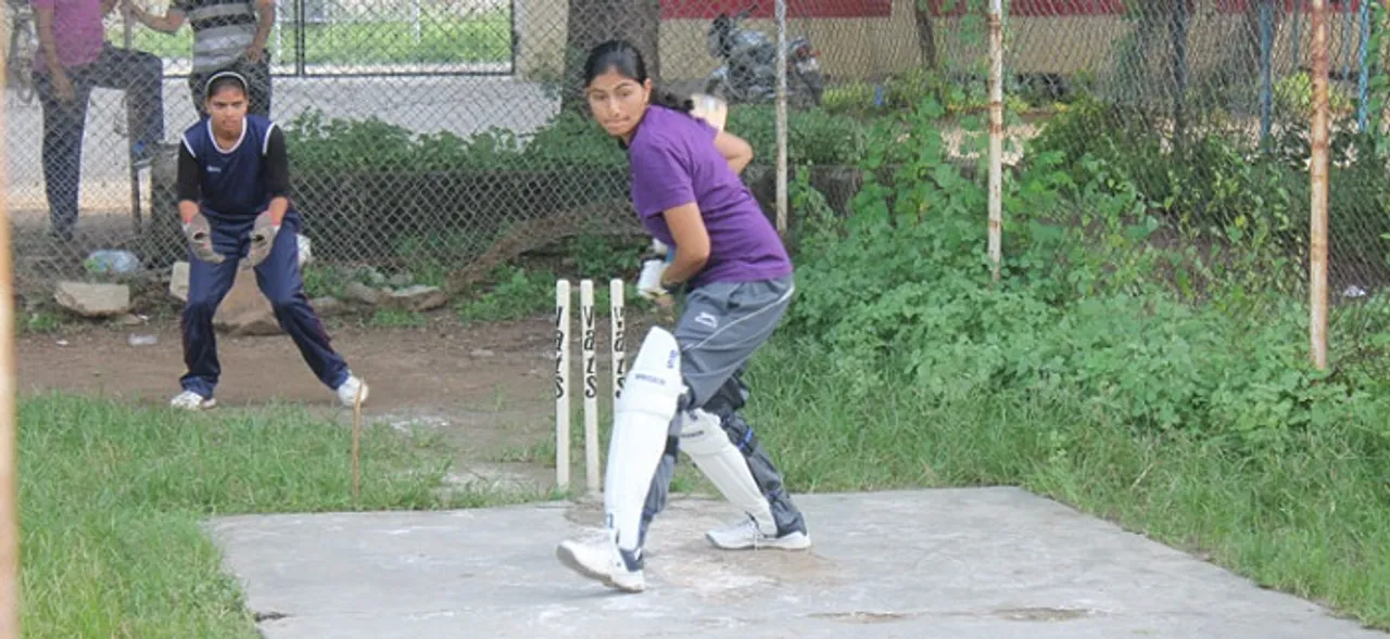 Women playing cricket