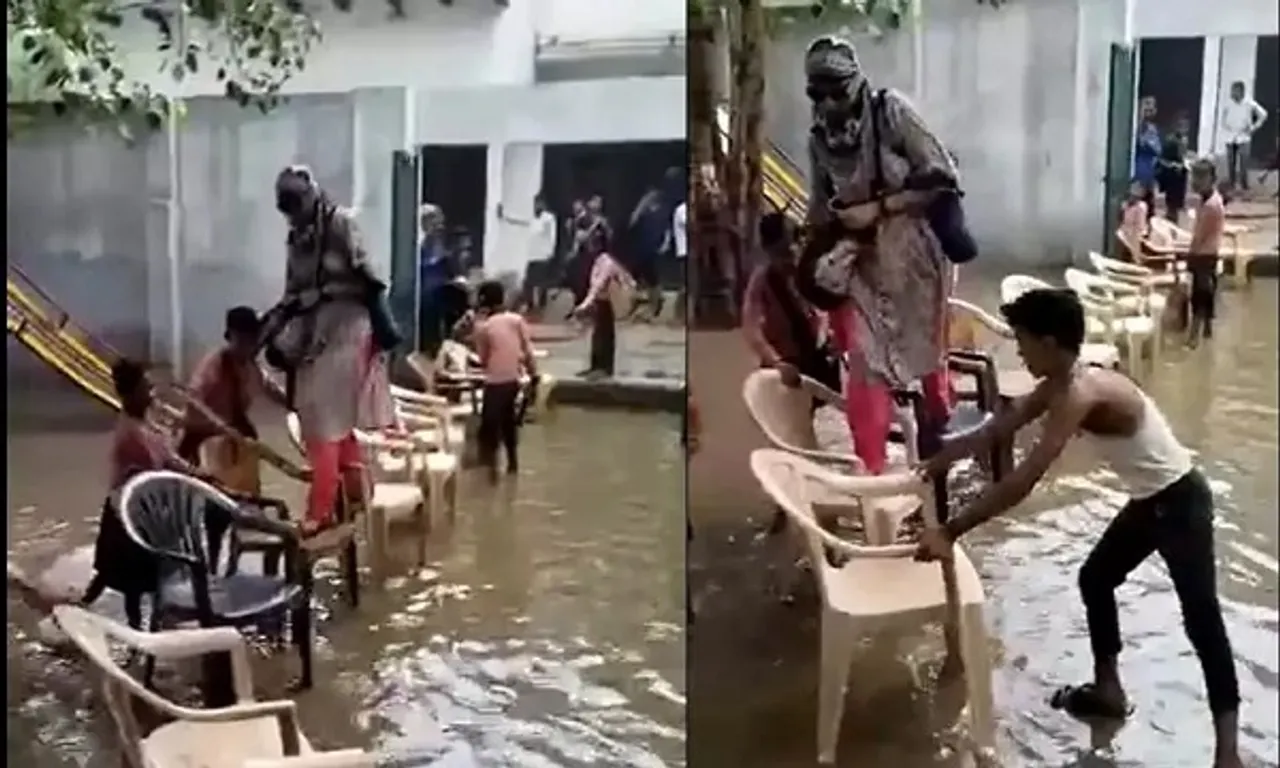 Video Shows Teacher Entering Flooded School On Chairs
