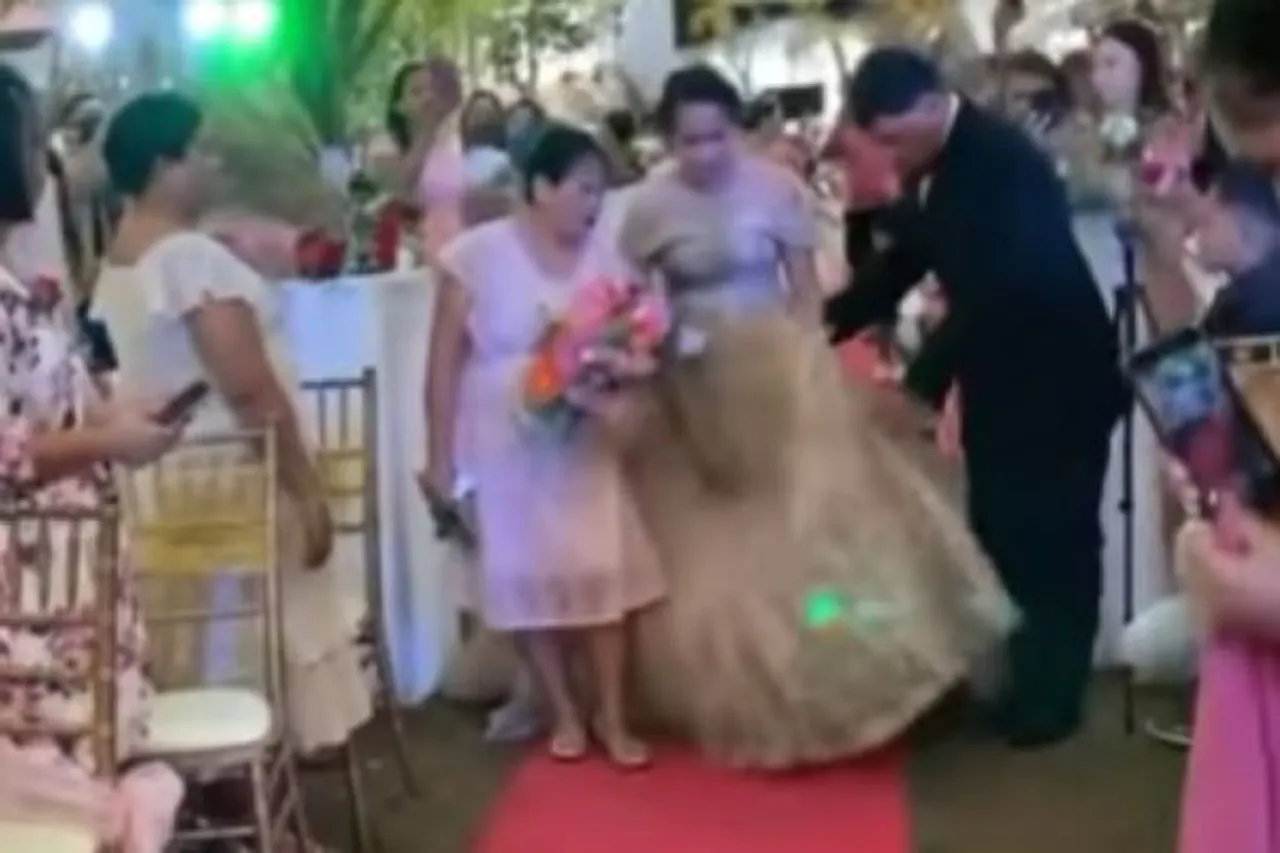 wedding planner hides under gown