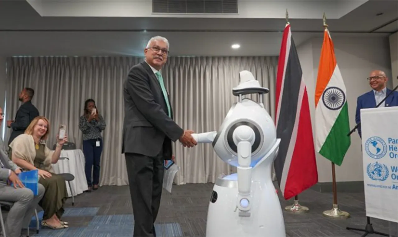 H.E. Terrence Deyalsingh, Minister of Health of Trinidad & Tobago, interacting with the healthcare service robots during the handover ceremony. PAHO