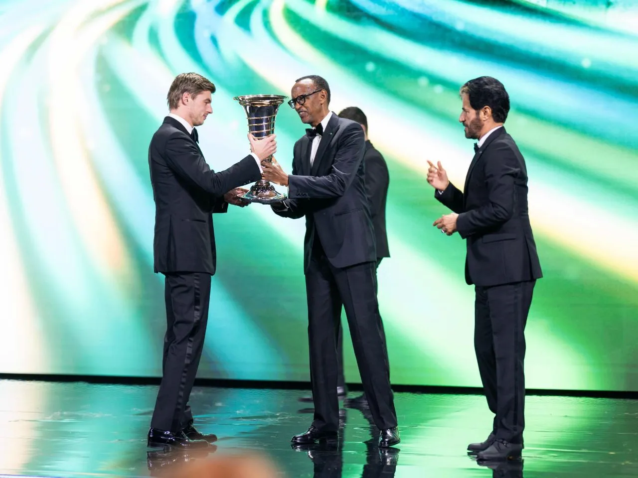 Max Verstappen receiving his F1 drivers championship from Rwanda President who wants the African Grand Prix in Kigali.