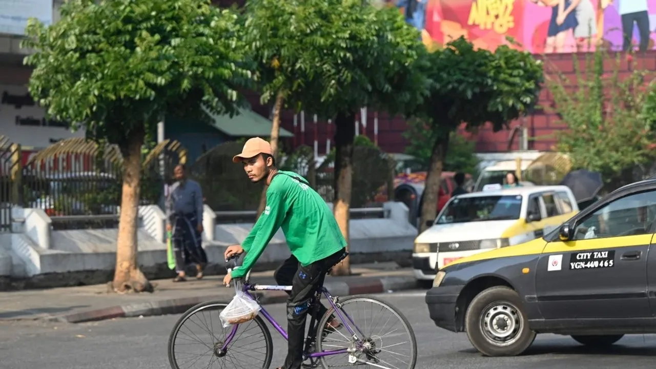 Delivery Riders in Yangon Struggle Through Heatwave on Bicycles