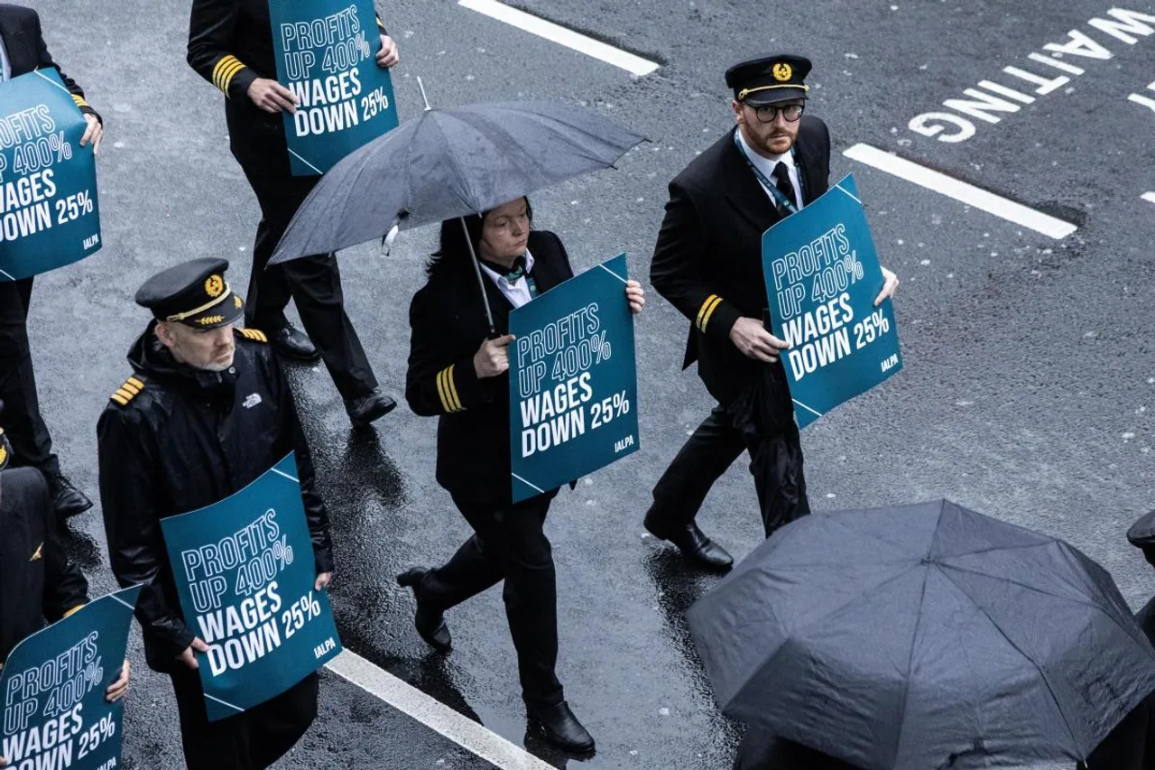 Hundreds of Aer Lingus pilots march around Dublin Airport in an eight-hour strike over pay.