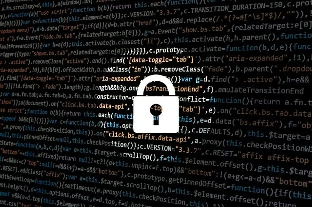 Padlock icon on computer screen with programming code in the background.