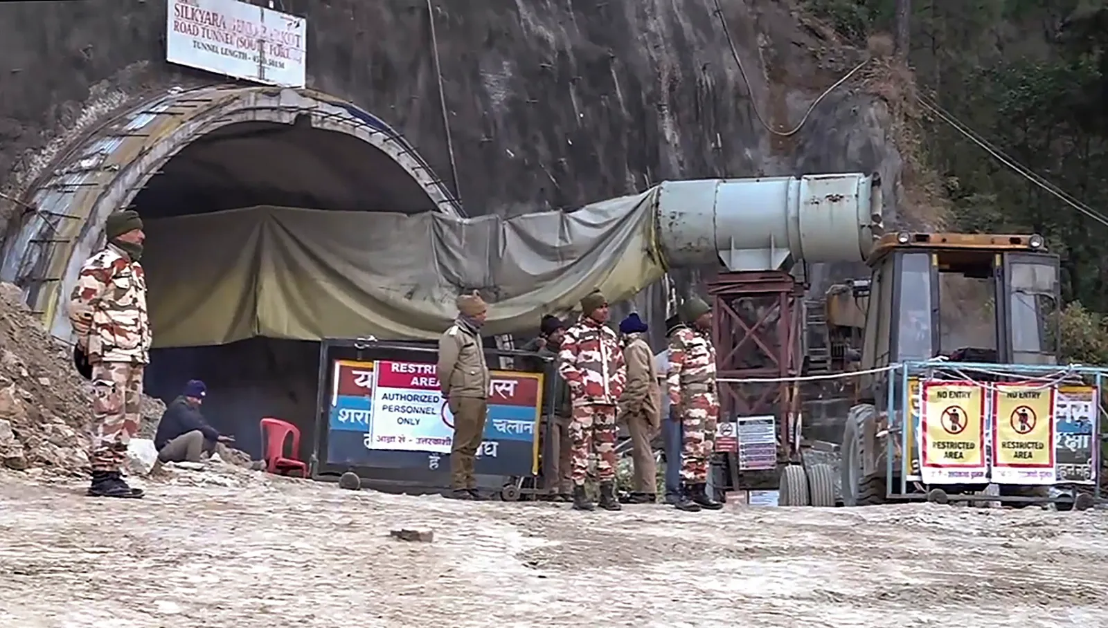 Security personnel outside the under-construction tunnel between Silkyara and Dandalgaon on the Brahmakhal-Yamunotri national highway