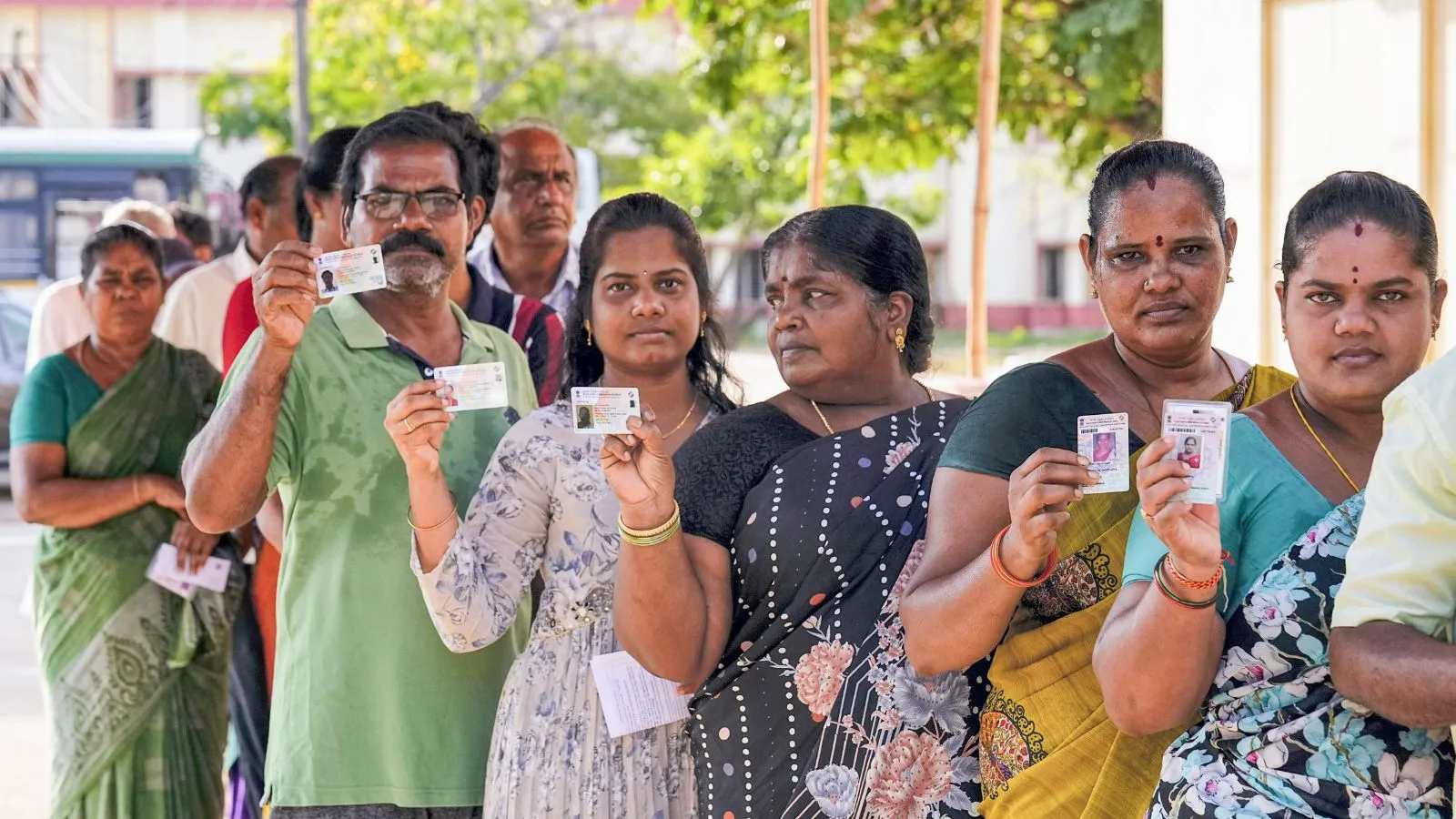 People stand in a queue to cast their votes at a polling station during the fourth phase of Lok Sabha elections and Andhra Pradesh Assembly elections, at Sullurupeta in Tirupati district, Monday, May 13, 2024