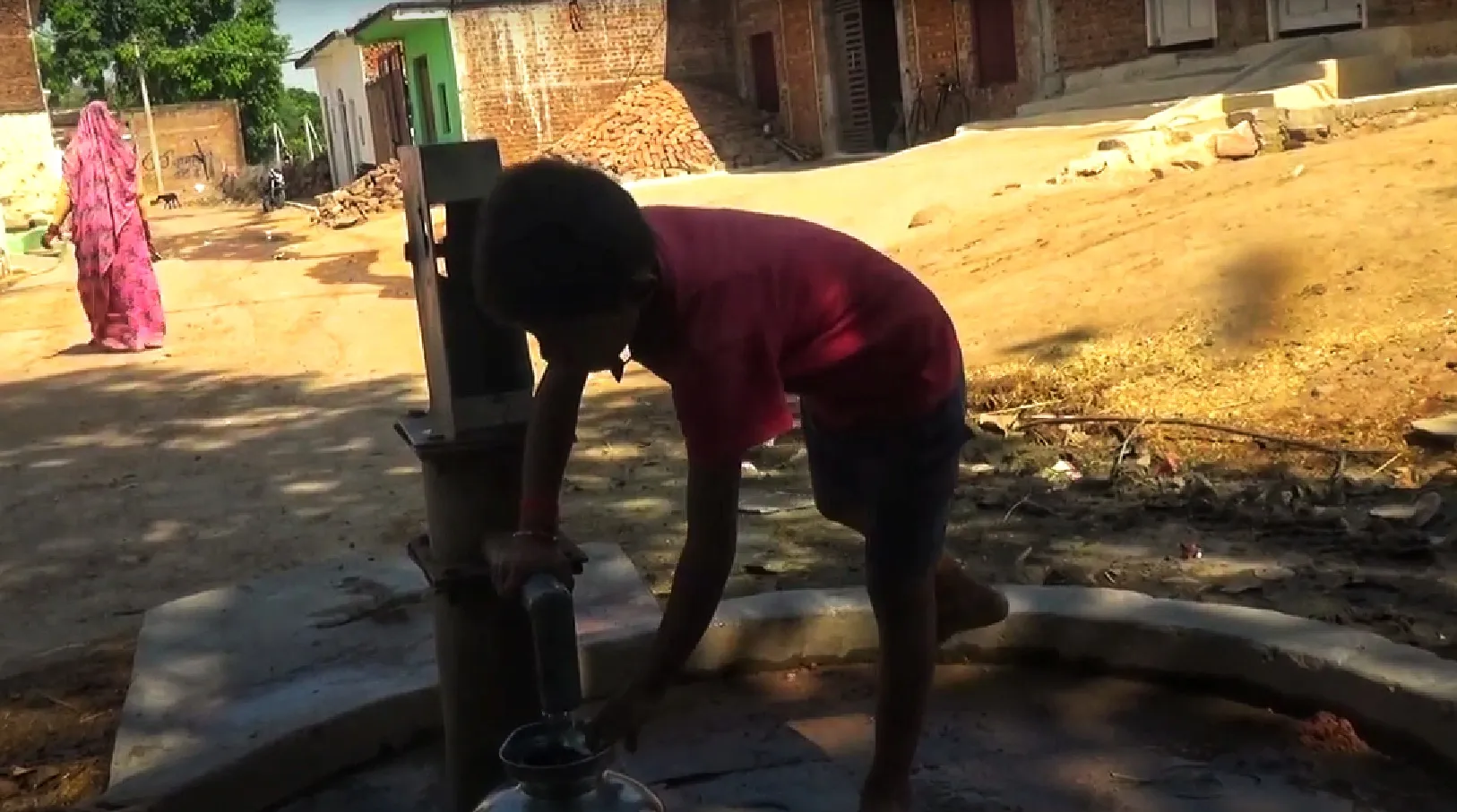 Girja's son, a 8-year-old boy fetching water