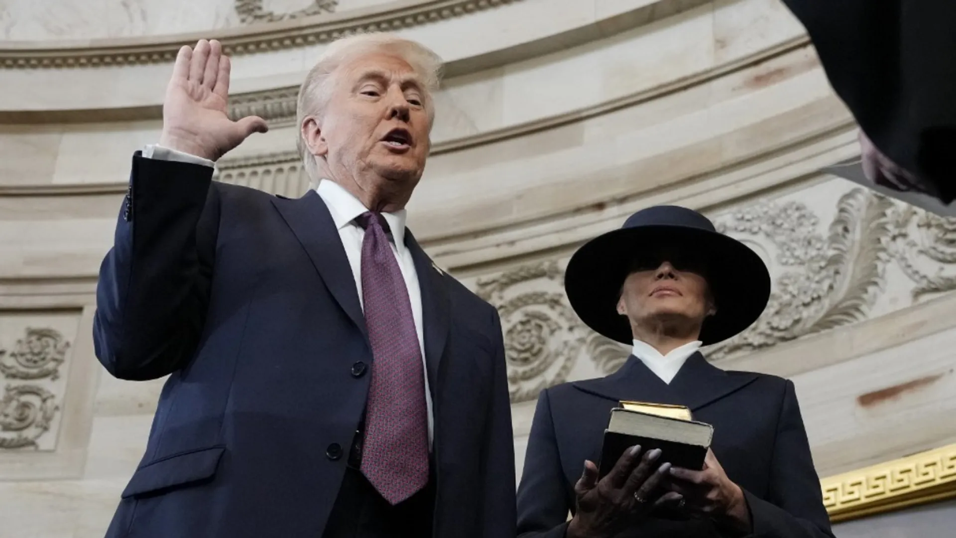 Donald Trump is sworn in as the 47th president of the United States by Chief Justice John Roberts as Melania Trump holds the Bible during the 60th Presidential Inauguration in the Rotunda of the U.S. Capitol in Washington, Monday, Jan. 20, 2025.