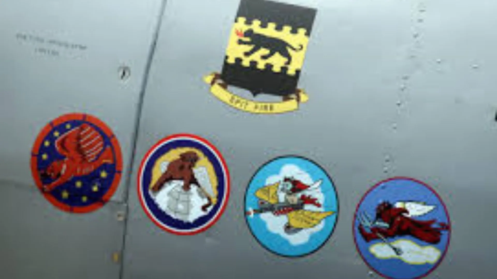 The insignias for the five Tuskegee Airmen squads are seen on the side of a Tuskegee Army Airfield AY-6 Texan fighter plane during a ceremony to honor the airmen at Selfridge National Airbase in Harrison Township, Michigan