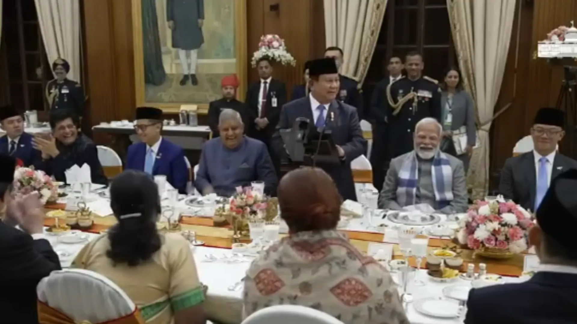 Prabowo Subianto (standing) seen cracking the Indian DNA joke with Indian PM Modi (right) and Vice President Dhankhar (left) laughing.