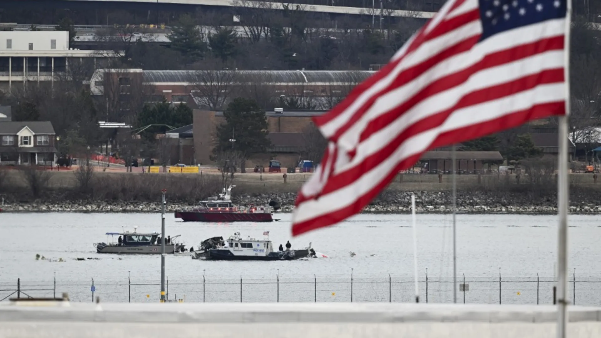 A police boat gathers wreckage along the Potomac River after American Airlines flight 5342 on approach to Reagan National Airport crashed into the river after colliding with a US Army helicopter, near Washington, DC, on January 30, 2025