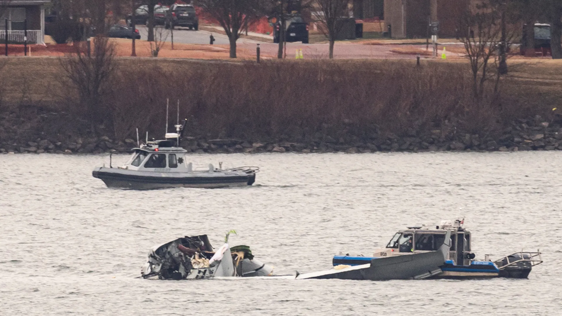 Recovery teams search the wreckage after the crash of an American Airlines plane on the Potomac River as it approached the airport on January 31, 2025 in Arlington, Virginia.