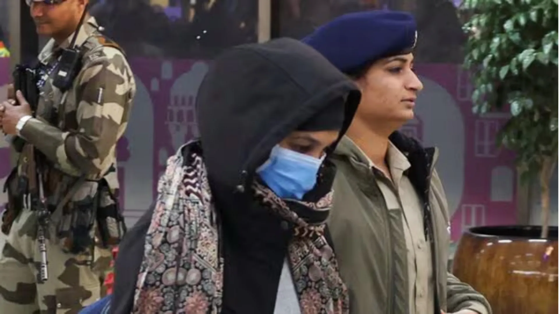 Police escort an Indian immigrant deported from the U.S. as they leave the airport in Ahmedabad 