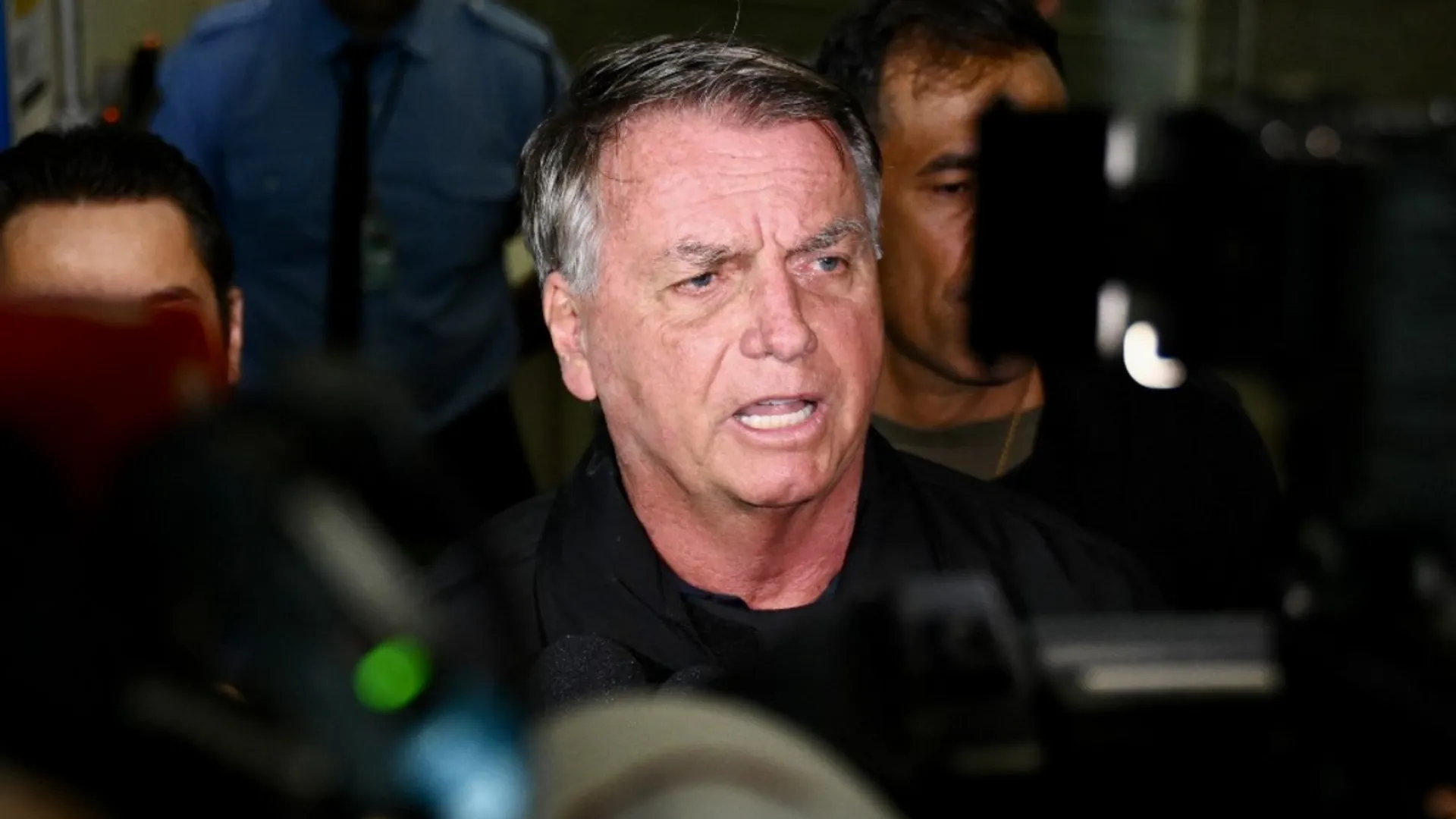 Former Brazilian President Jair Bolsonaro speaks to members of the media at Brasilia airport on January 18, 2025.
