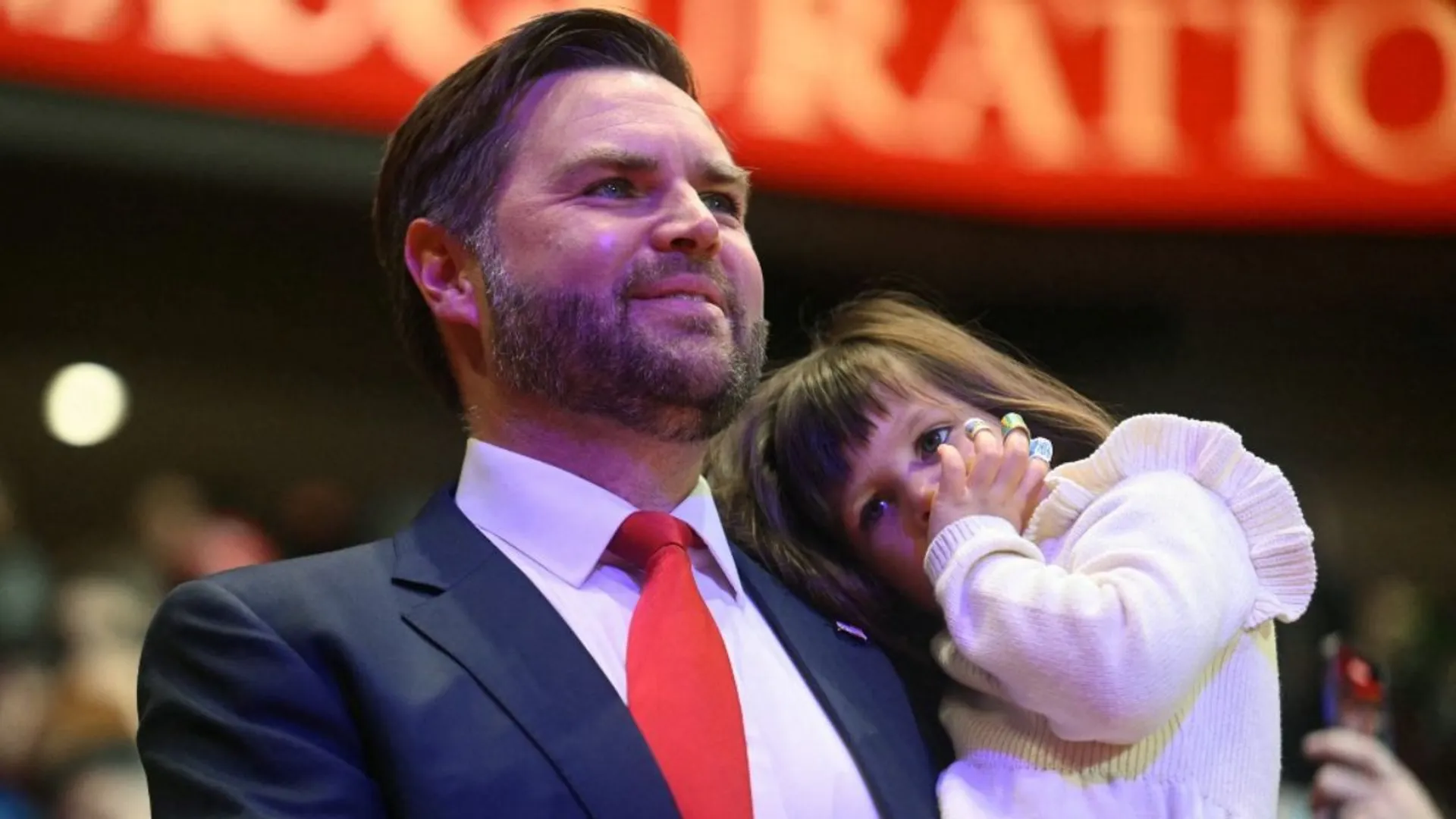 US Vice President JD Vance holds his daughter Mirabel as he arrives for the inaugural parade inside Capital One Arena, in Washington, DC, on January 20, 2025.