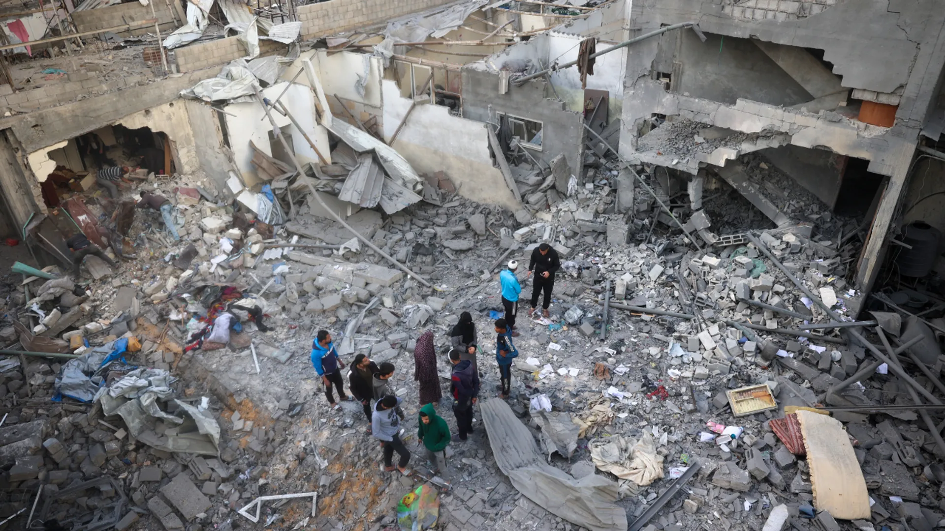 Residents look at the remains of their homes, destroyed in an Israeli strike, at the Nuseirat refugee camp in the central Gaza Strip on March 18, 2025