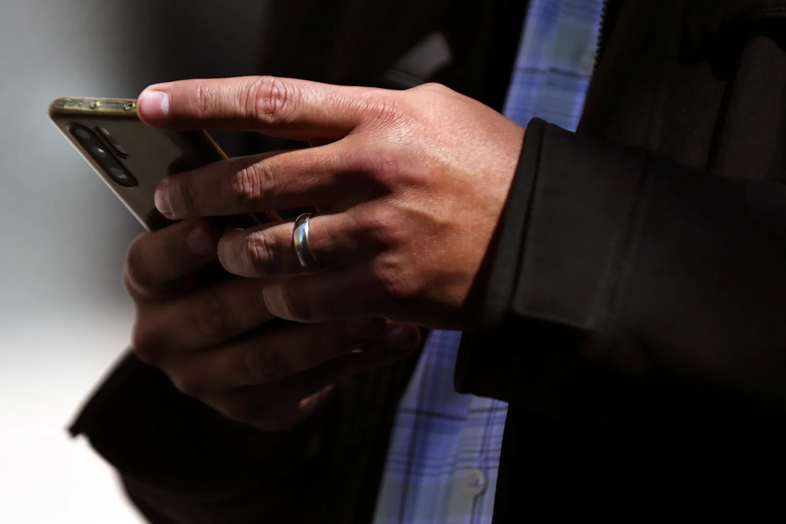 A man holds his mobile phone