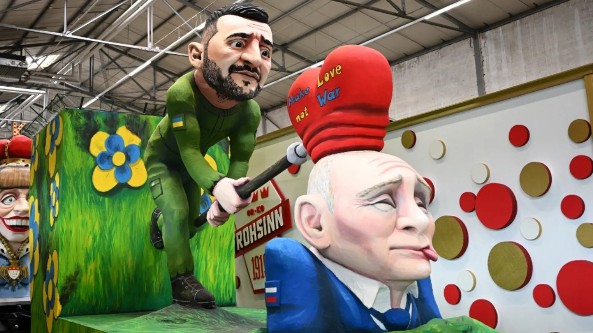 A carnival float showing Ukraine's President Volodymyr Zelensky hitting Russia's President Vladimir Putin with a heart reading 'Make Love not War' is pictured during a presentation of this year's carnival floats of Cologne's carnival committee in Cologne, on February 25, 2025.
