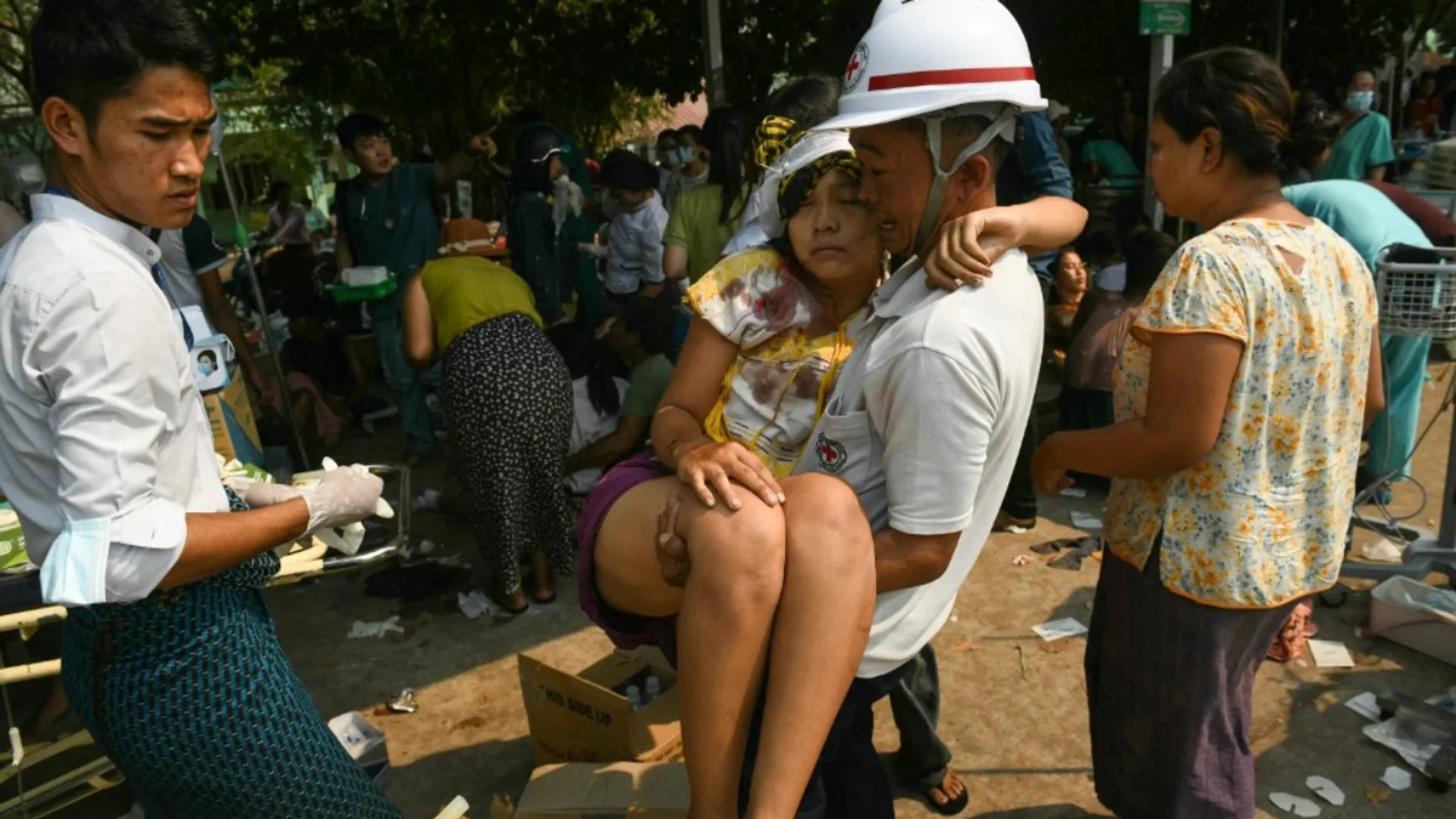 An earthquake survivor is carried as she waits to receive medical attention at a hospital in Naypyidaw on March 28, 2025, after an earthquake in central Myanmar. A powerful earthquake rocked central Myanmar on March 28, buckling roads in capital Naypyidaw, damaging buildings and forcing people to flee into the streets in neighbouring Thailand.