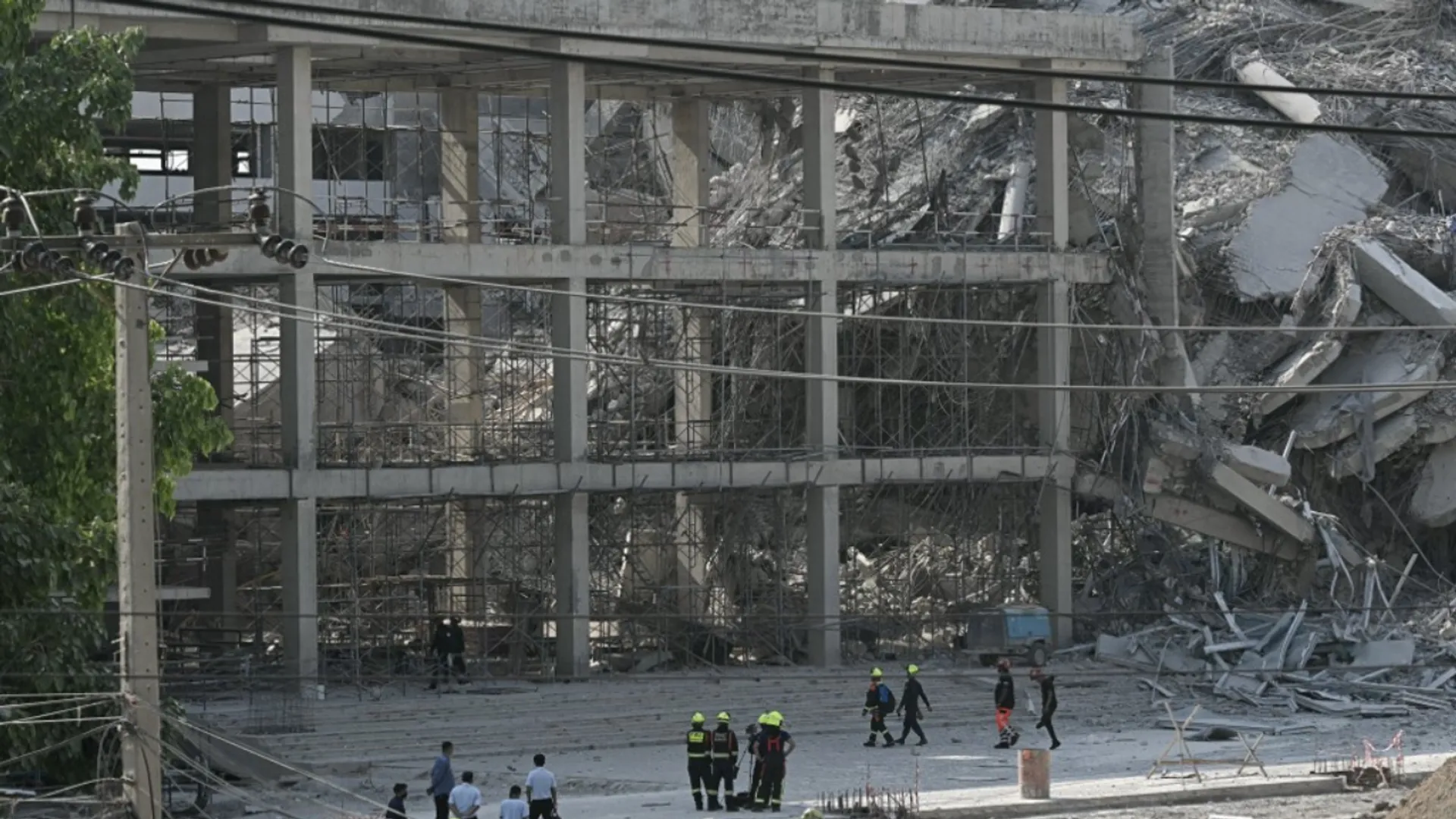 Rescue workers look at the debris of a construction site after a building collapsed in Bangkok on March 28, 2025, following an earthquake. A powerful earthquake rocked central Myanmar on March 28, buckling roads in capital Naypyidaw, damaging buildings and forcing people to flee into the streets in neighbouring Thailand.