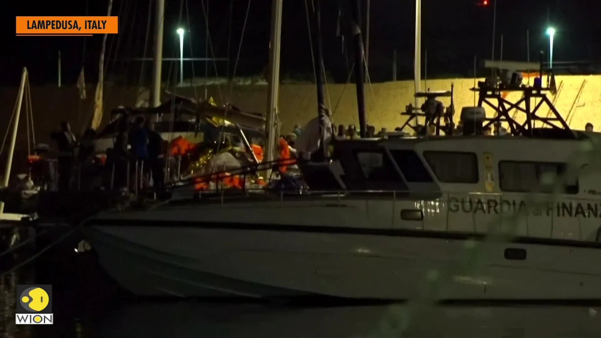 Migrants disembark in Lampedusa port