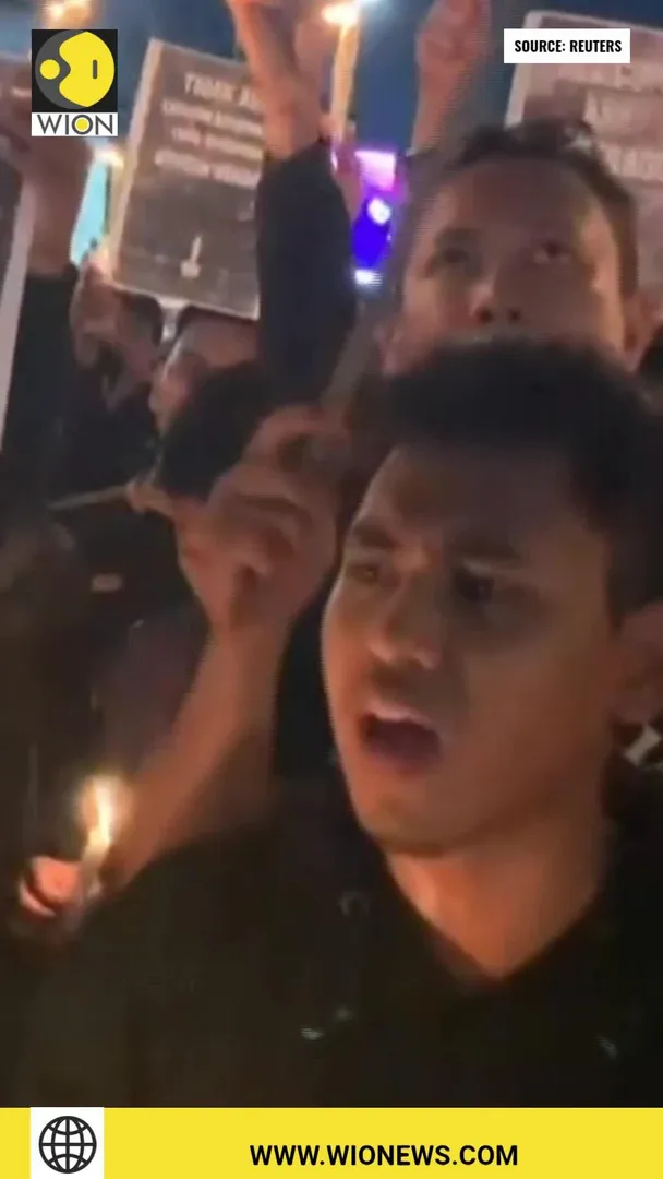 Hundreds attend a candlelight vigil for Indonesia's football riot victims