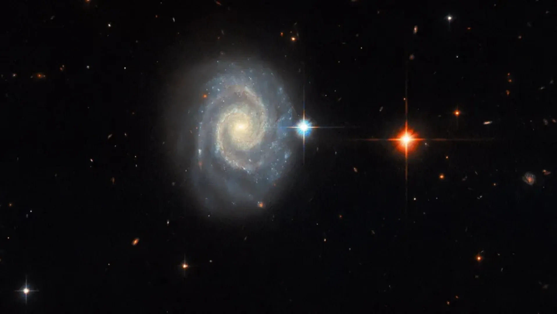 Celestial masterpiece: Forbidden light of distant spiral galaxy captured by Hubble
