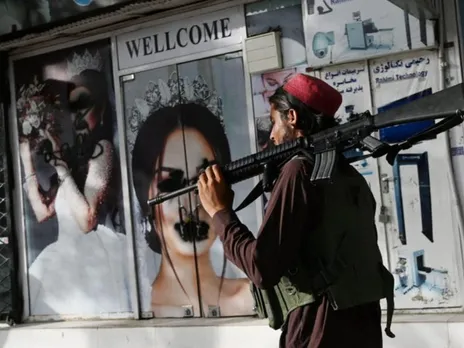 Taliban man outside a beauty salon in Afghanistan.jpeg