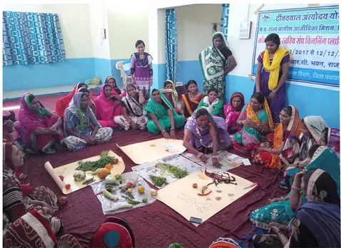 Women learning about nutrition during a 'poshan mela