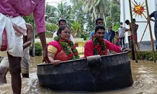 Viral image: Amid the rainfall in Kerala, The couple reached their Wedding Hall in cooking vessel; See pic!