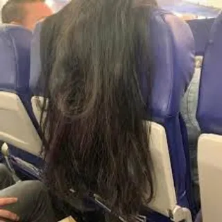 Viral photo of women's hair Slung over seat in flight has twitter fuming !