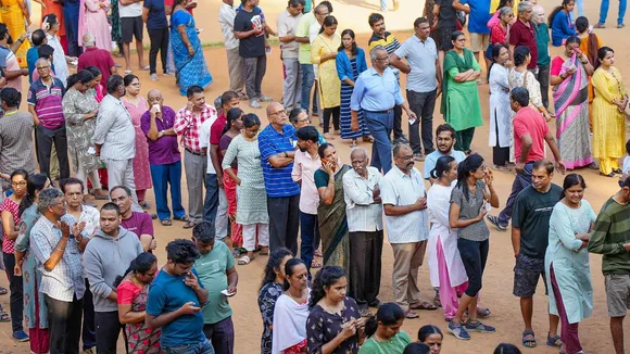 People wait to cast their votes for the 2nd phase of Lok Sabha elections, in Bengaluru, Friday, April 26, 2024. 