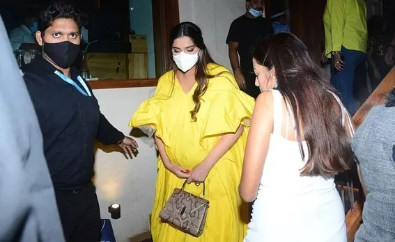 SONAM KAPOOR SPOTTED IN A YELLOW DRESS AFTER DINNER PARTY .