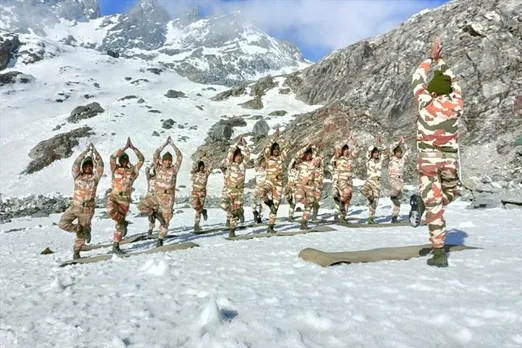 Army soldiers practicing yoga in a snow-covered white sheet