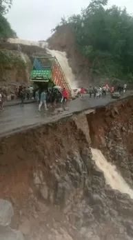 Truck down as road caves in: watch dramatic video