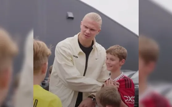 'Loyal man right there' - Fans react as Erling Haaland covers Man Utd badge on young fan's chest while posing for photo